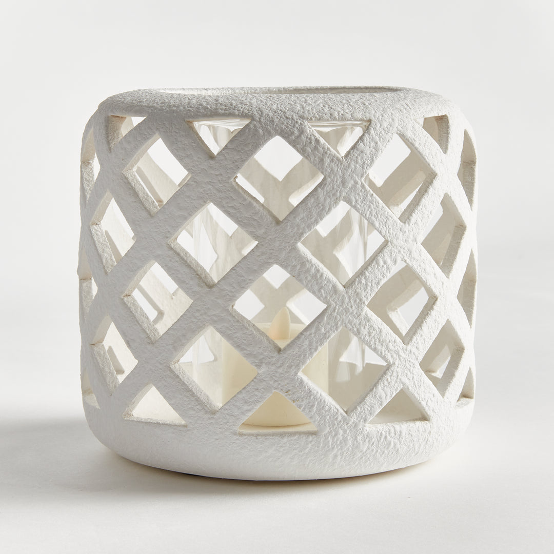 Front angled view of small white terracotta hurricane candle holder with lattice detailing – Coastal Transitional style.
