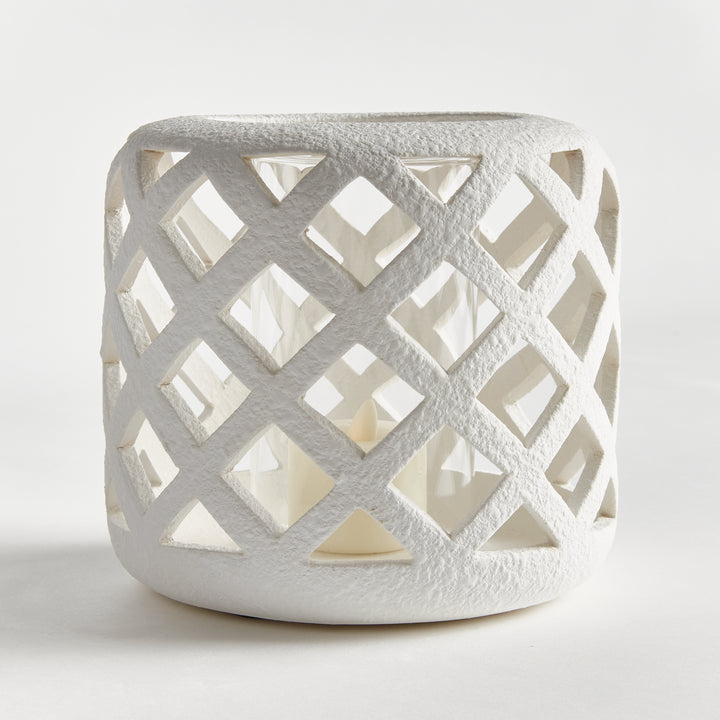 Front angled view of small white terracotta hurricane candle holder with lattice detailing – Coastal Transitional style.