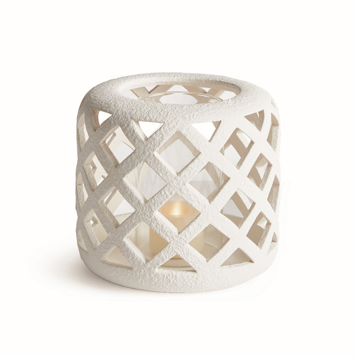 Small white terracotta hurricane candle holder with lattice cutout detailing and glass insert – Coastal Transitional style.