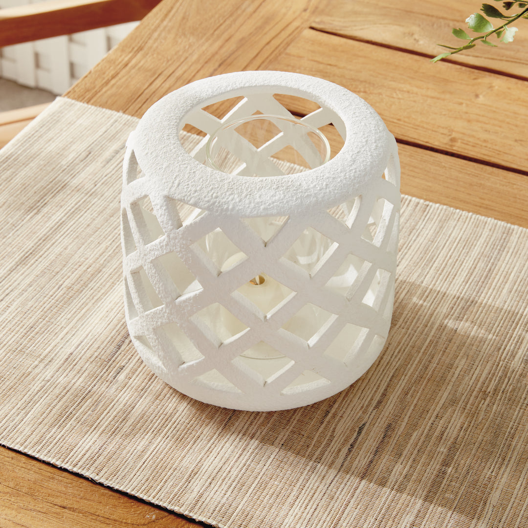 Small white terracotta hurricane candle holder styled on console table with candlelight – Coastal Transitional style.