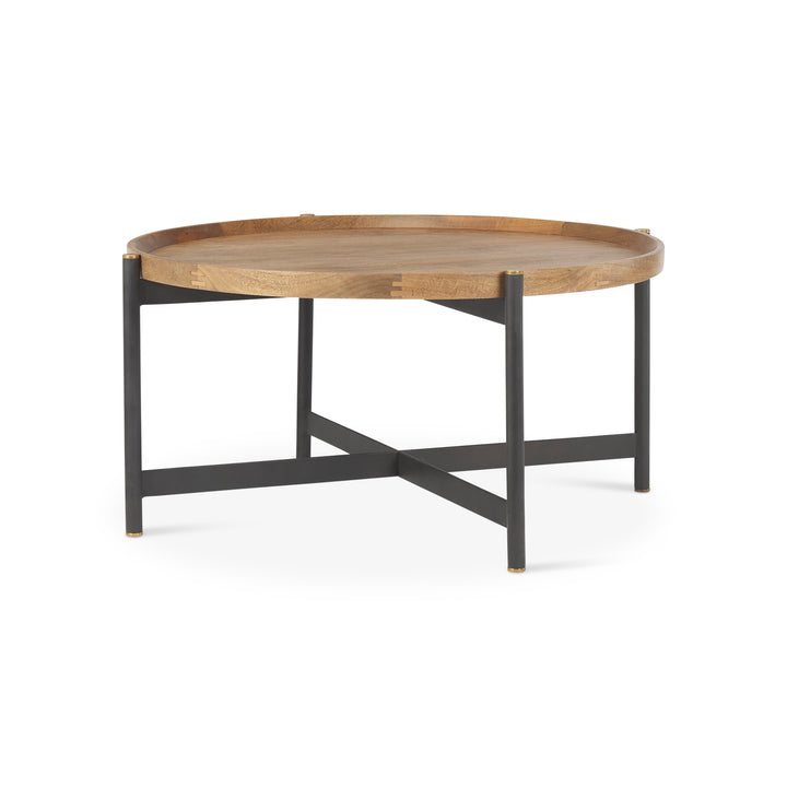Small round mango wood coffee table with black iron base in front view featuring a solid wood top and open metal frame, Modern Organic coffee table