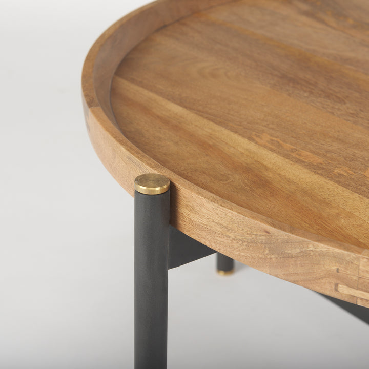 Close-up of the rounded mango wood tabletop edge with black iron frame and gold leg cap detail, Modern Organic coffee table