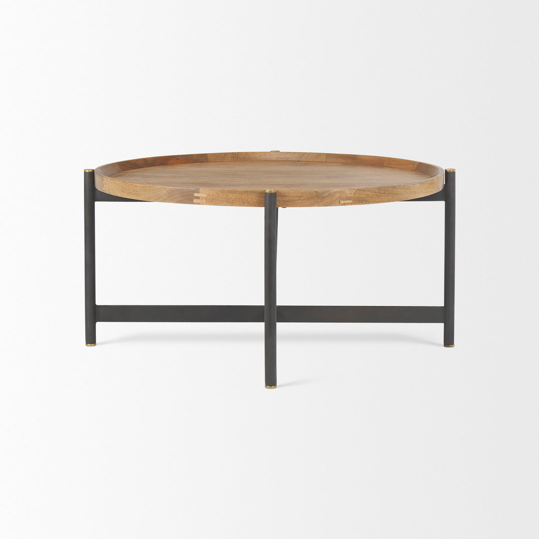 Profile view of a small round mango wood coffee table with solid mango wood top and black iron frame, Modern Organic coffee table