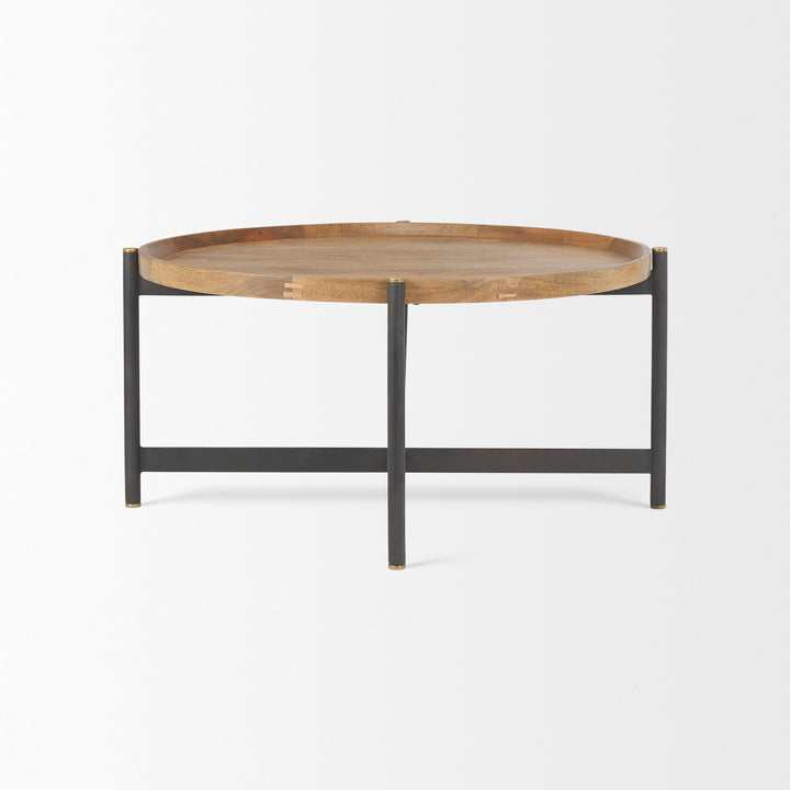 Profile view of a small round mango wood coffee table with solid mango wood top and black iron frame, Modern Organic coffee table