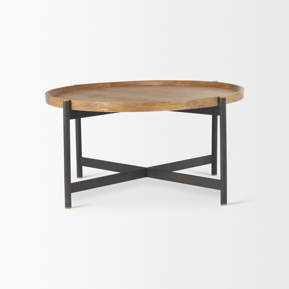 Side angle of a small round mango wood coffee table with black iron base highlighting the handcrafted wood top, Modern Organic coffee table
