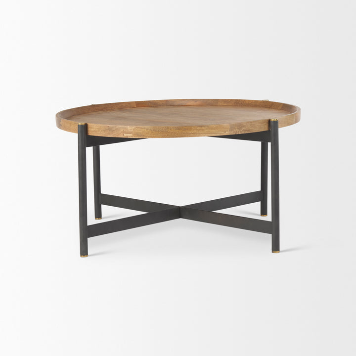 Side angle of a small round mango wood coffee table with black iron base highlighting the handcrafted wood top, Modern Organic coffee table
