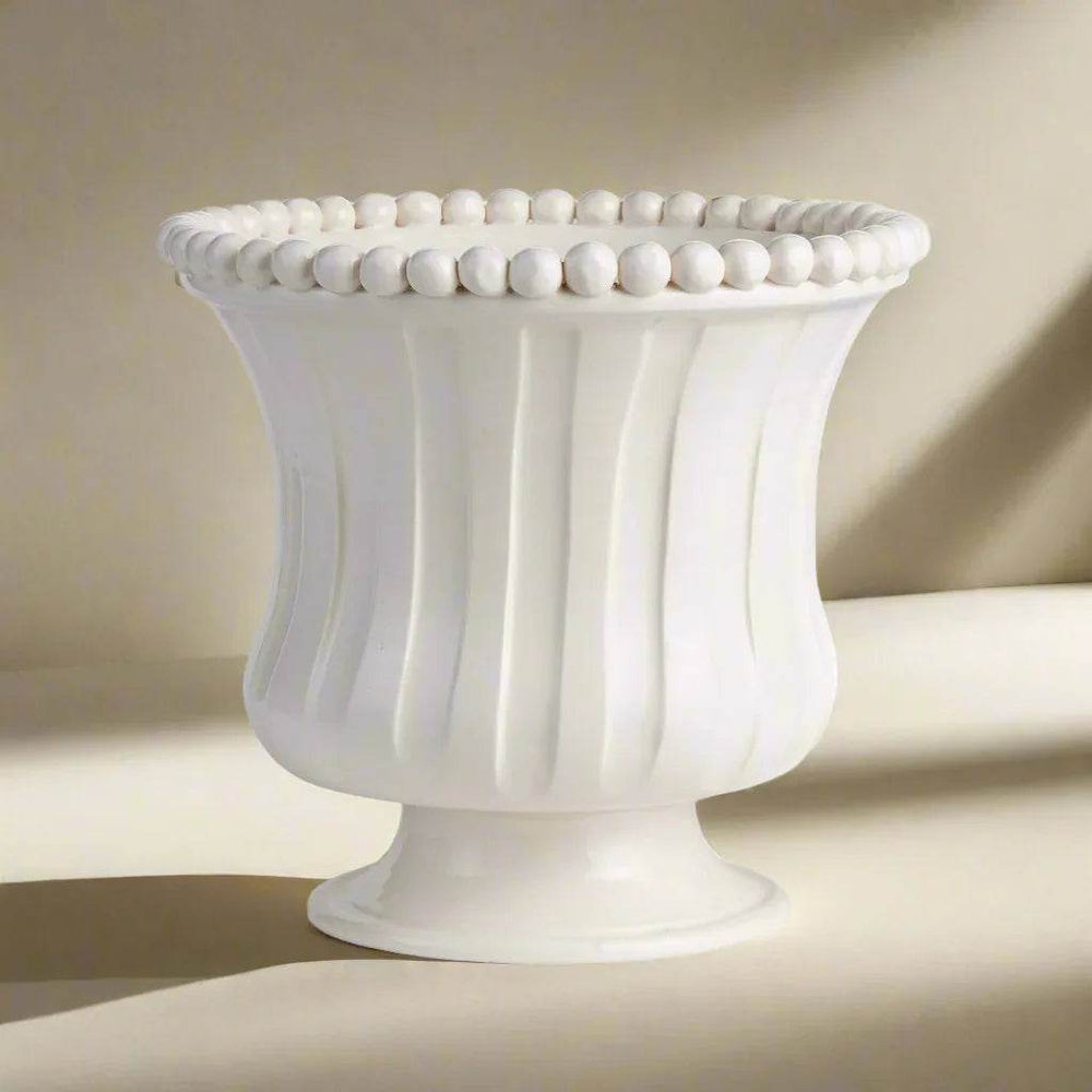 Side view of small white ceramic flared vase with pedestal base, ribbed texture, and beaded rim, handmade in Italy decor – French Country.

