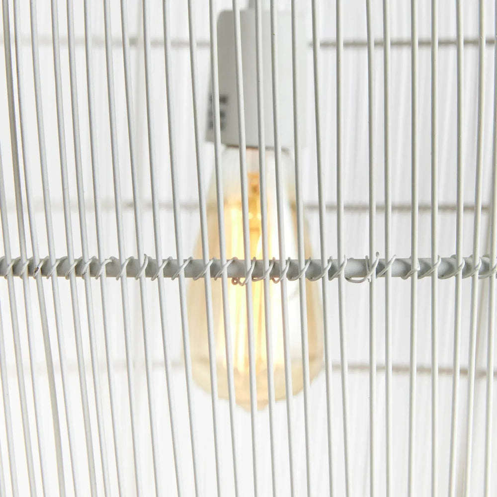Close view of the small white woven iron pendant light, showing the exposed bulb behind slender metal strands, Coastal style
