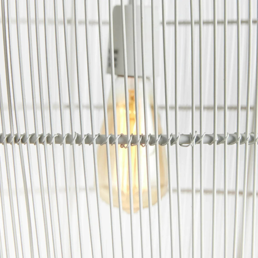 Close view of the small white woven iron pendant light, showing the exposed bulb behind slender metal strands, Coastal style