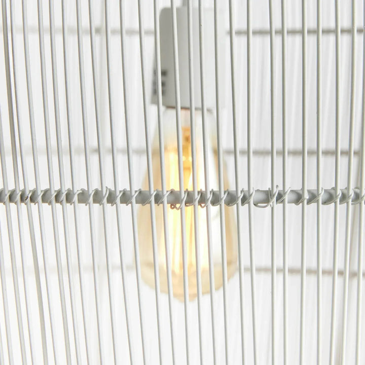 Close view of the small white woven iron pendant light, showing the exposed bulb behind slender metal strands, Coastal style