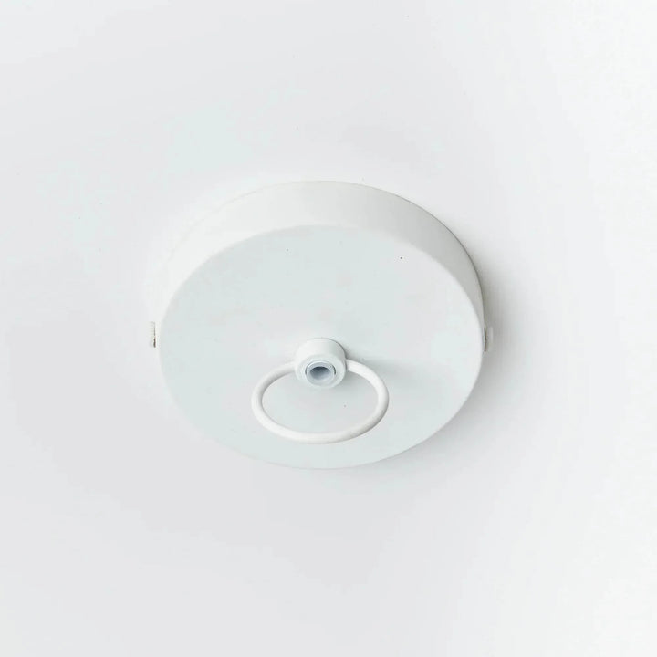 Small white pendant ceiling canopy viewed from above, showing the round plate, loop and painted metal finish, Coastal style