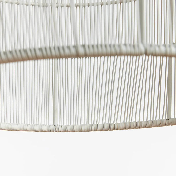 Small white iron pendant shade detail showing closely spaced metal strands wrapped around round support rings, Coastal style