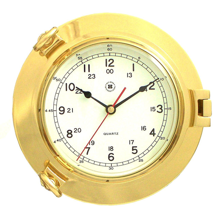 Solid brass porthole wall clock with beveled glass and round quartz dial shown front view for coastal home decor style