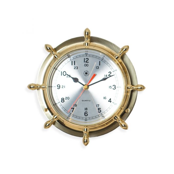 This Nautical Ship's Wheel Clock in Brass adds a touch of maritime charm to any room. Adorned with a ships wheel and featuring a precise quartz clock, this wall clock is both functional and stylish. The brass and beveled glass design is sure to impress any nautical enthusiast.