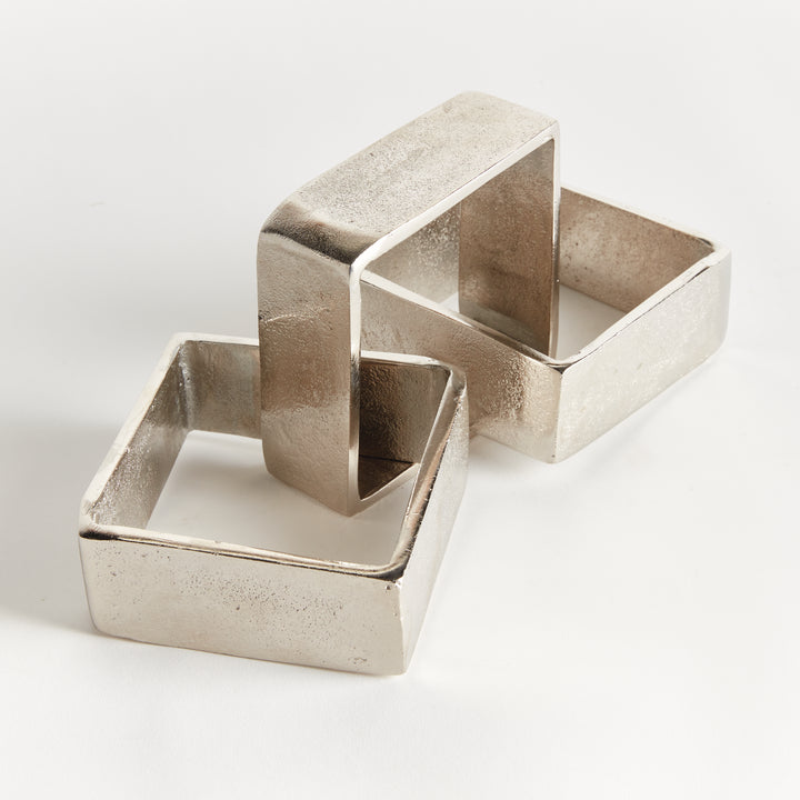 Angled view of silver chain-link sculpture with cast aluminum links open centers and textured metal on white - Modern Organic