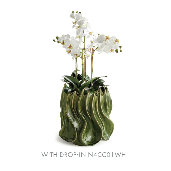 Sylva large green vase holding a white orchid bowl drop-in with arching stems and leaves on a pale background. Modern Organic