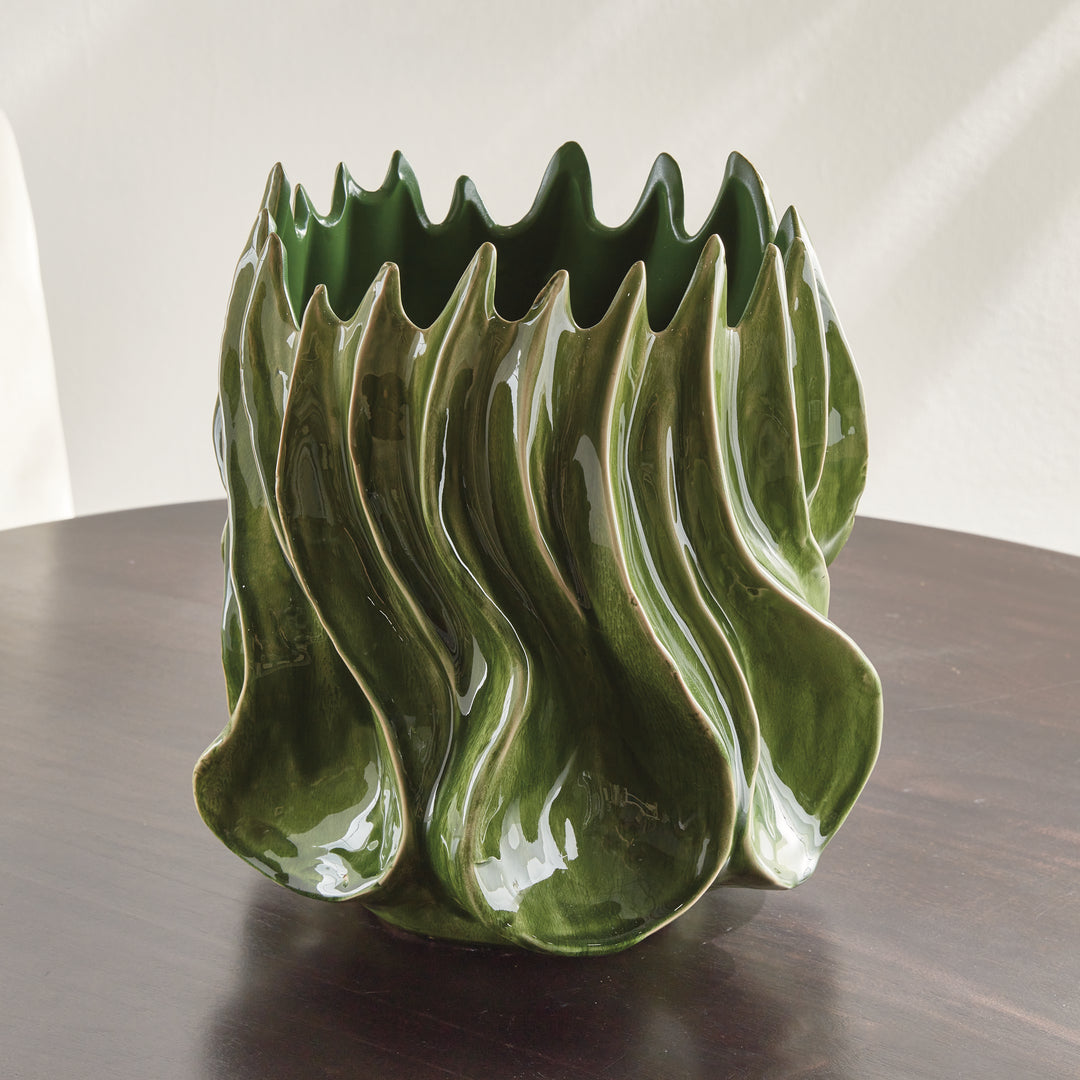 Sylva large green ceramic vase unfilled on a dark tabletop with raised curves catching the natural light. Modern Organic