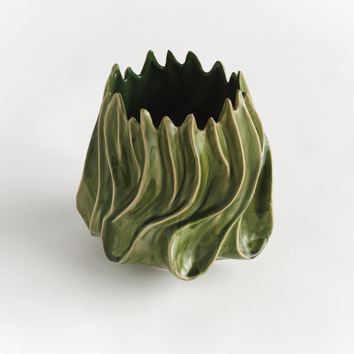 Angled view of Sylva medium green vase showing its open pointed rim and sculptural body on a pale background. Modern Organic