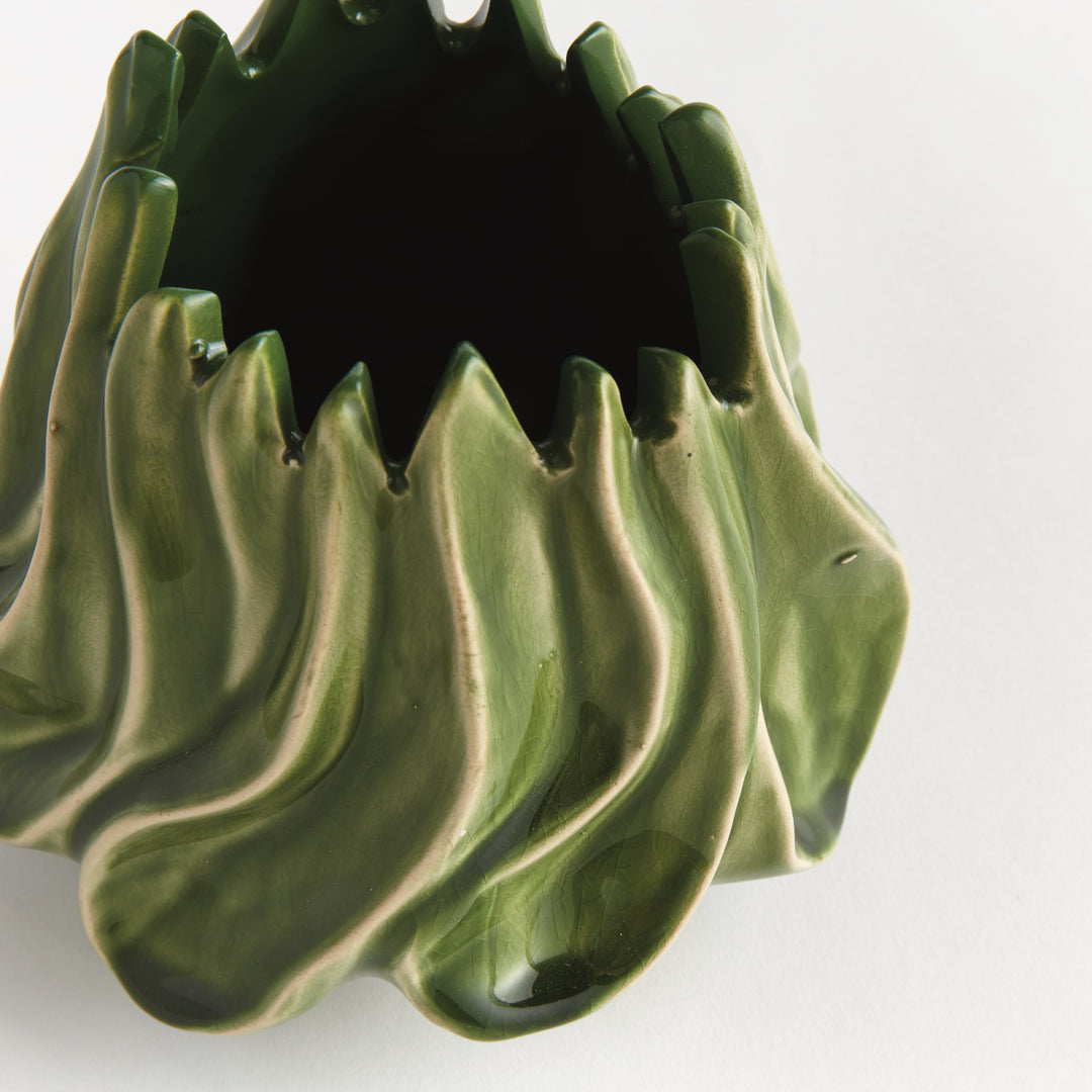 Close view of Sylva small vase showing glossy green reactive glaze over raised curves beneath the pointed rim. Modern Organic