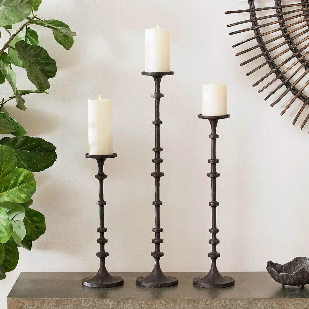 Set of 3 tall industrial black bronze candle stands styled on mantel with pillar candles and greenery – Industrial Interior