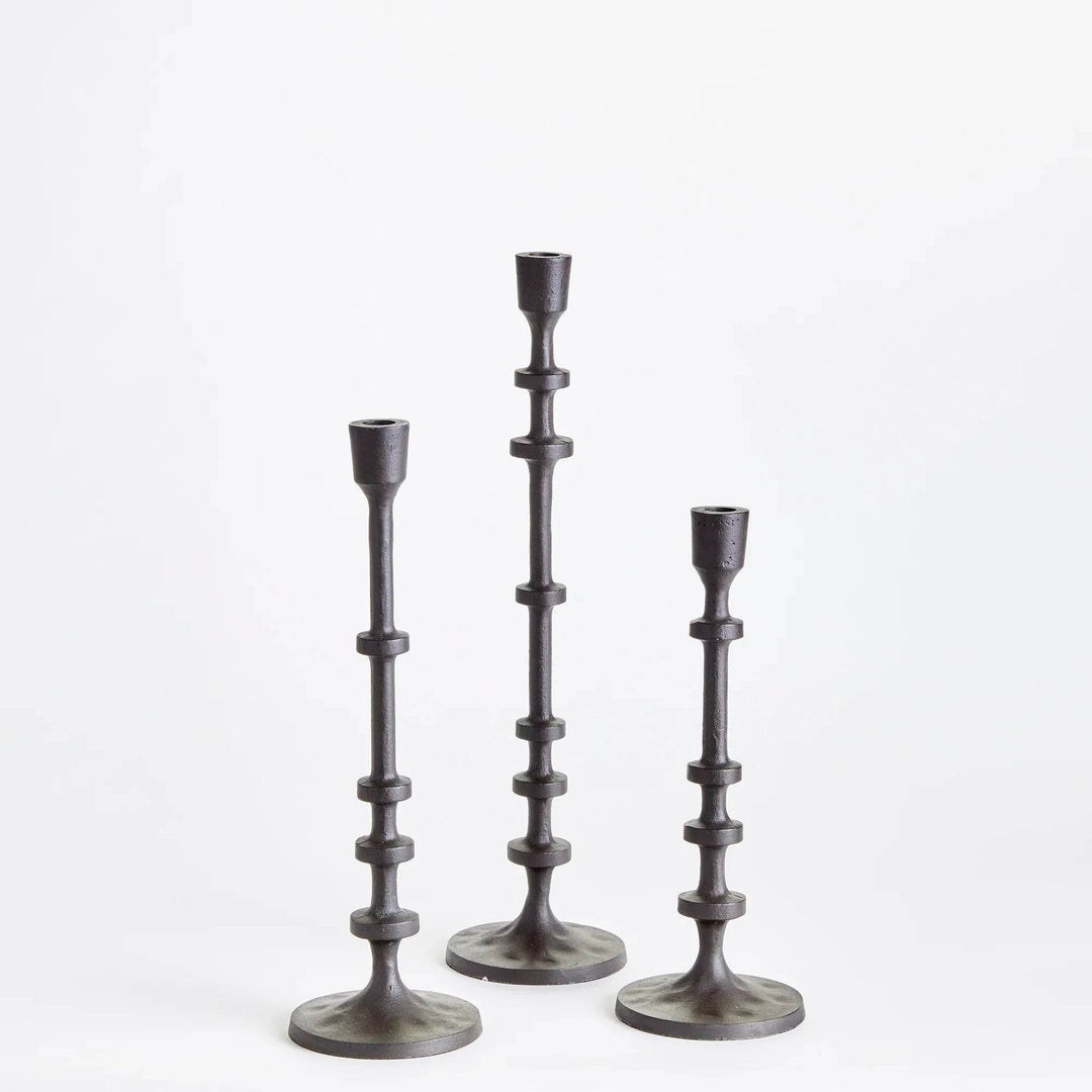 Full set of three bronze taper candle holders in graduated industrial design
