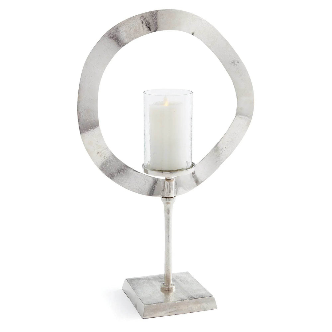 Tall silver candle stand with glass hurricane shown on white background, sculptural metal candle holder for home styling – Minimalist Glam.

