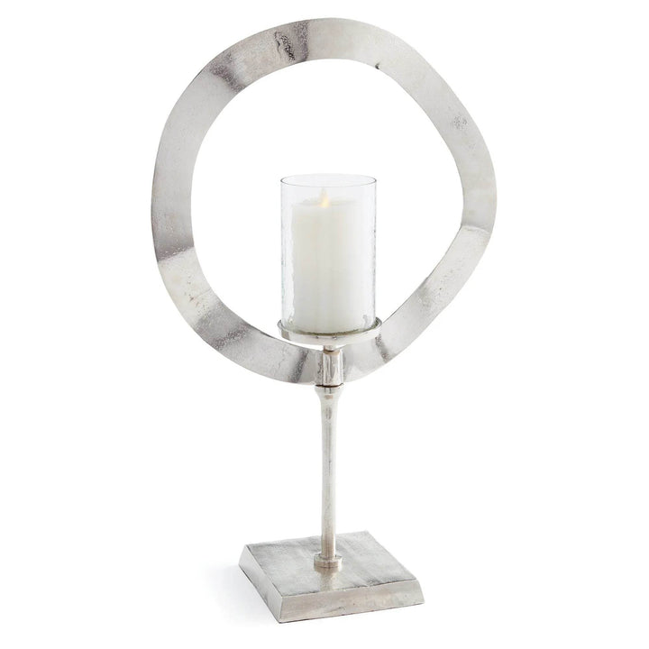 Tall silver candle stand with glass hurricane shown on white background, sculptural metal candle holder for home styling – Minimalist Glam.

