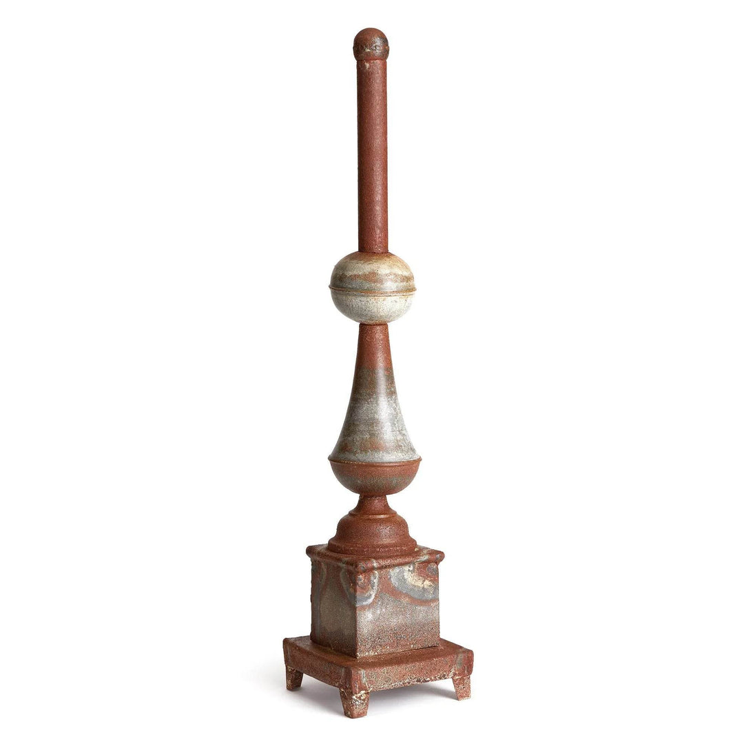 Tall weathered metal decorative finial on woven rug with baskets, antique galvanized finish accent for entryway or living room – Vintage Farmhouse.

