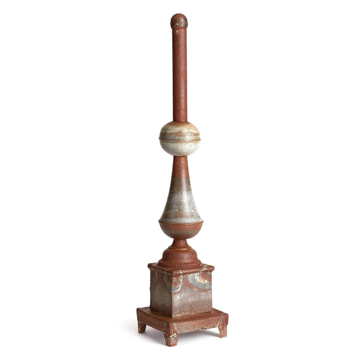 Tall weathered metal decorative finial on woven rug with baskets, antique galvanized finish accent for entryway or living room – Vintage Farmhouse.

