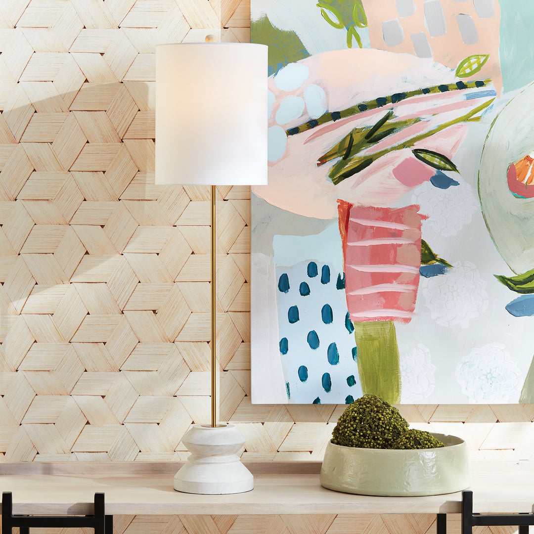 Whitewashed mango wood table lamp styled near colorful wall art, slender metal stem highlighted
