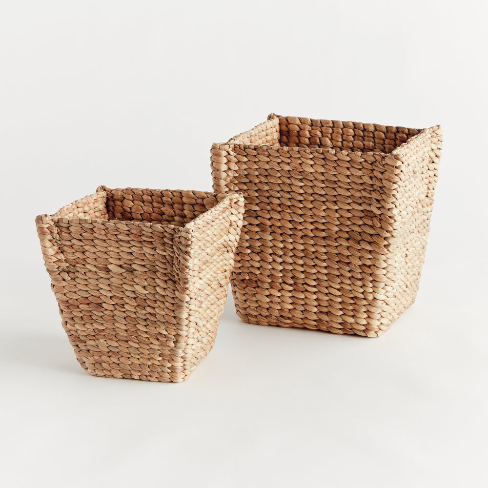 Angled view of Tamsin natural tan tapered basket pair showing square open tops and textured water hyacinth sides. Coastal