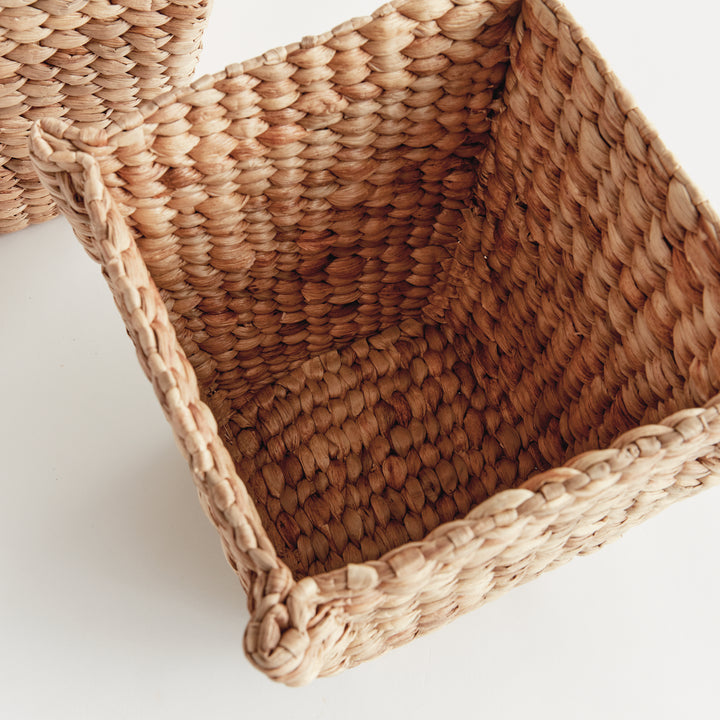 Interior view of Tamsin square basket showing its thick tan woven walls, corner structure and water hyacinth base. Coastal