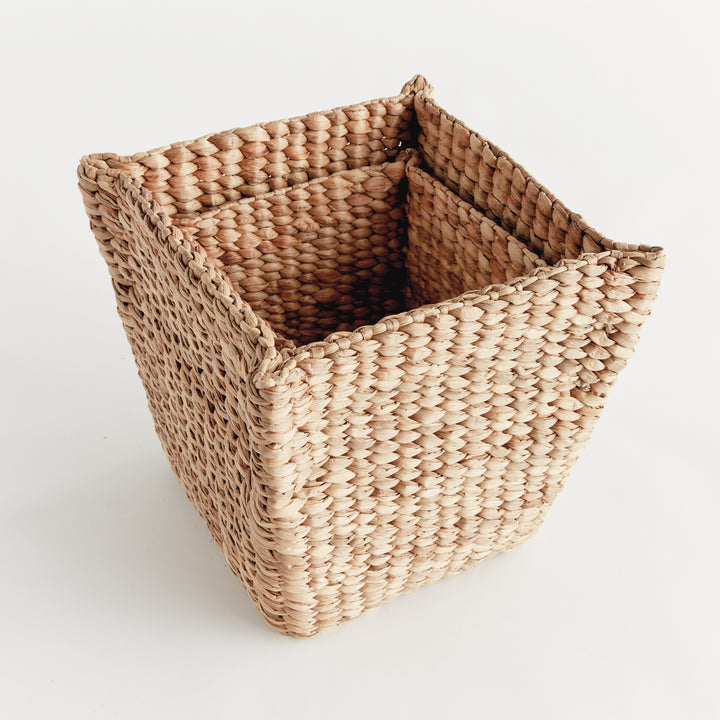 Tamsin small tapered water hyacinth basket nested inside the larger square basket against a plain white background. Coastal