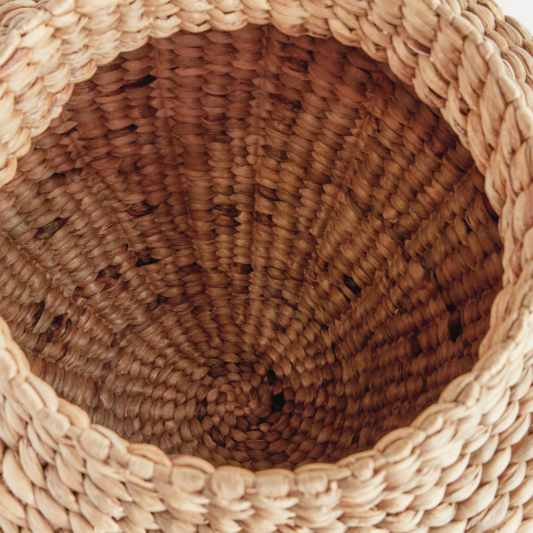 Interior detail of Tamsin water hyacinth urn showing woven walls and circular base beneath its thick natural rim. Coastal