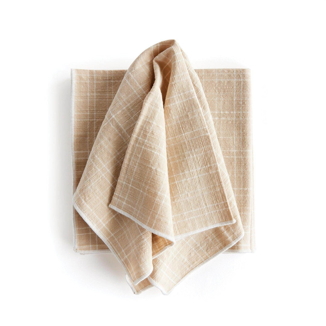 Taupe cotton dinner napkin draped over folded base napkin to show arch grid weave and soft handfeel detail - Modern Organic.