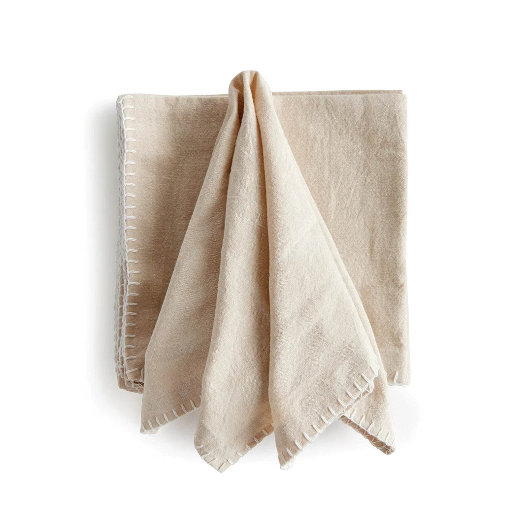 Set of four taupe cotton dinner napkins with stitched edges, soft fabric displayed in a casual draped fold – Modern Farmhouse.