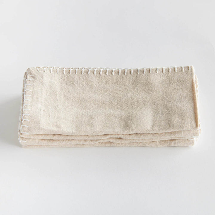 Single taupe cotton napkin laid flat with stitched edge detail visible, simple neutral design for everyday dining – Modern Farmhouse.