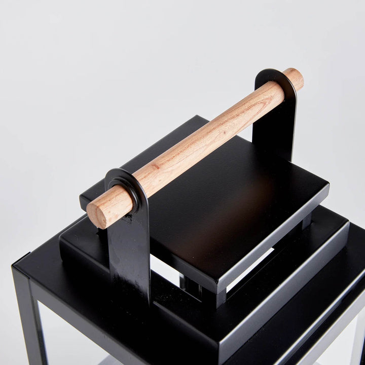 Close up of teak handle on small black outdoor lantern