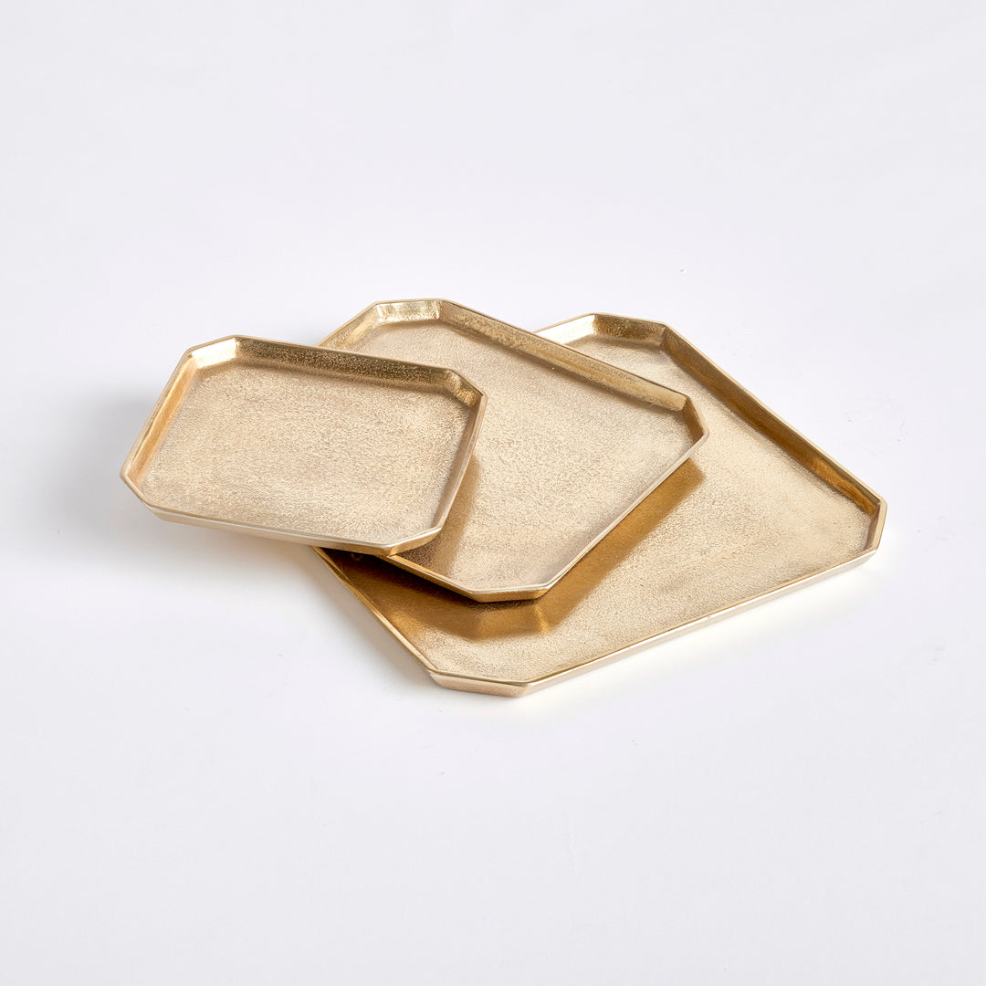 Set of three textured gold square cast aluminum serving trays layered in a geometric tabletop arrangement, Transitional style