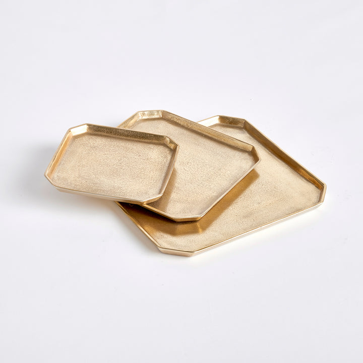 Set of three textured gold square cast aluminum serving trays layered in a geometric tabletop arrangement, Transitional style