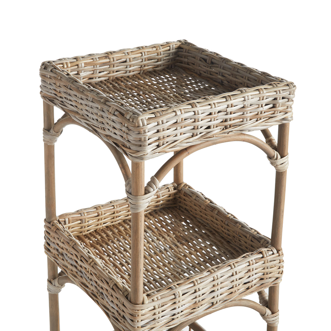 Detailed view of top two woven baskets on natural rattan shelving unit in a coastal boho finish.