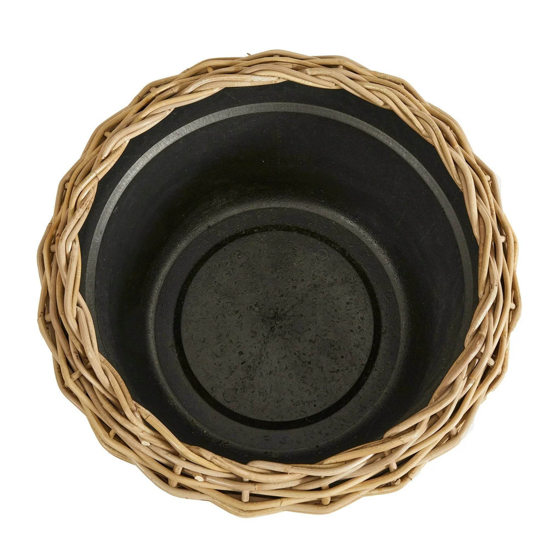Top-down view of rattan planter showing internal grower's pot and rim weave in natural boho style
