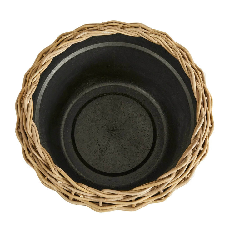 Top-down view of rattan planter showing internal grower's pot and rim weave in natural boho style