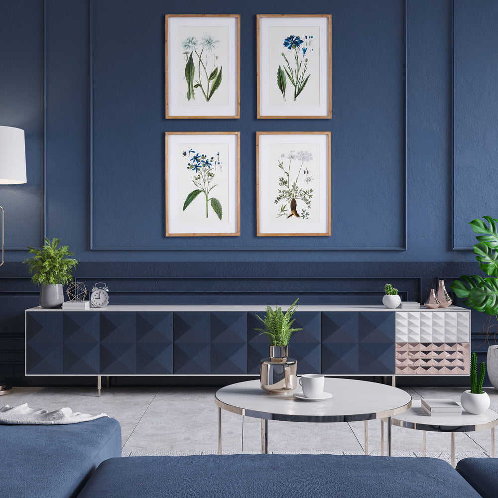  Blue botanical wall art set styled above navy console in coastal living room with natural accents.

