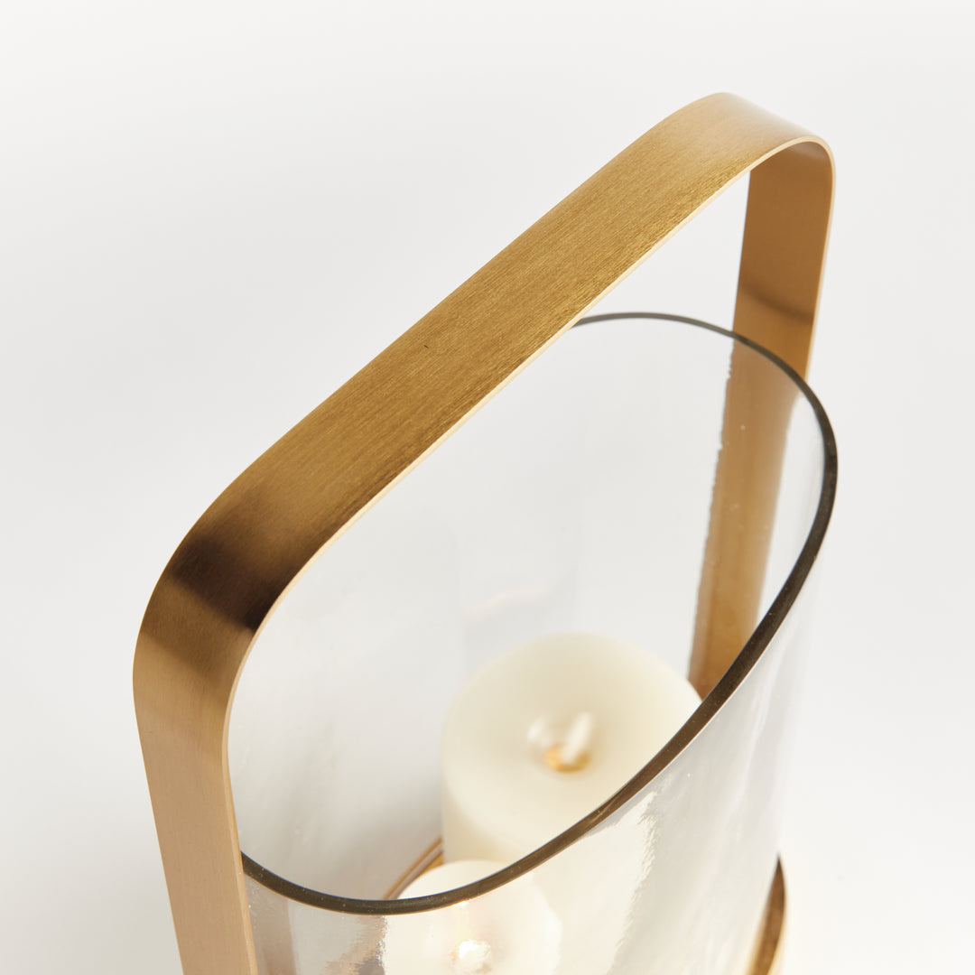 Detail of the handle and rim on the small transitional brass and glass hurricane candle holder in warm matte brass.