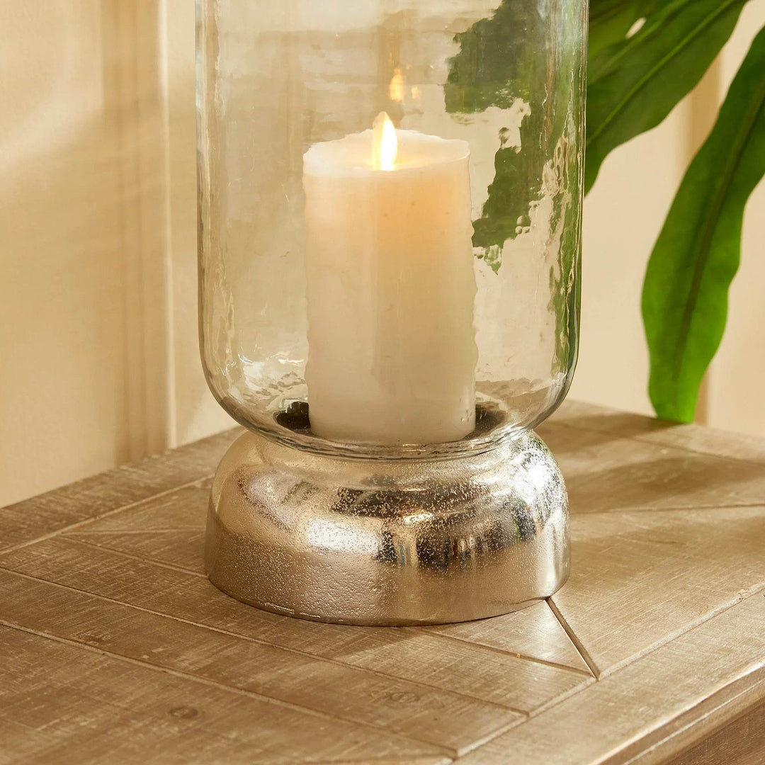Angled lifestyle view of hurricane holder on wood console with candle lit inside – Transitional Modern

