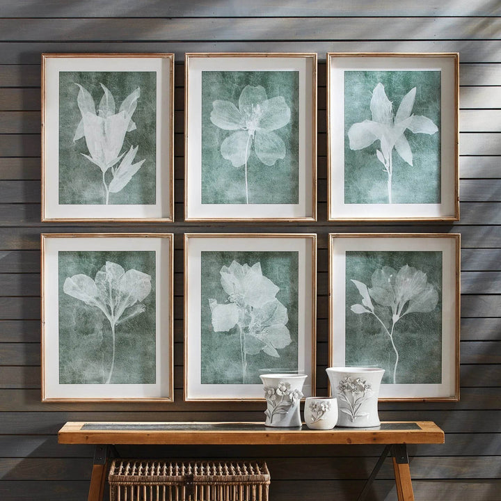 Translucent floral wall prints styled in a modern natural wood-paneled room with ceramic vases and soft light
