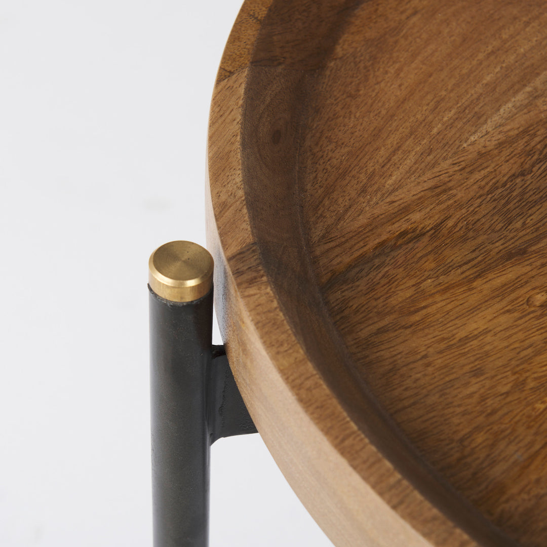 Close-up of raised mango wood tray edge with black iron leg and gold metal cap detail – Modern Organic