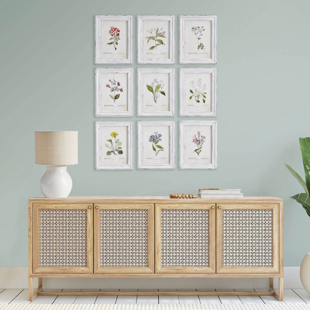 Vintage botanical wall art set of 9 with distressed white frames styled above console table