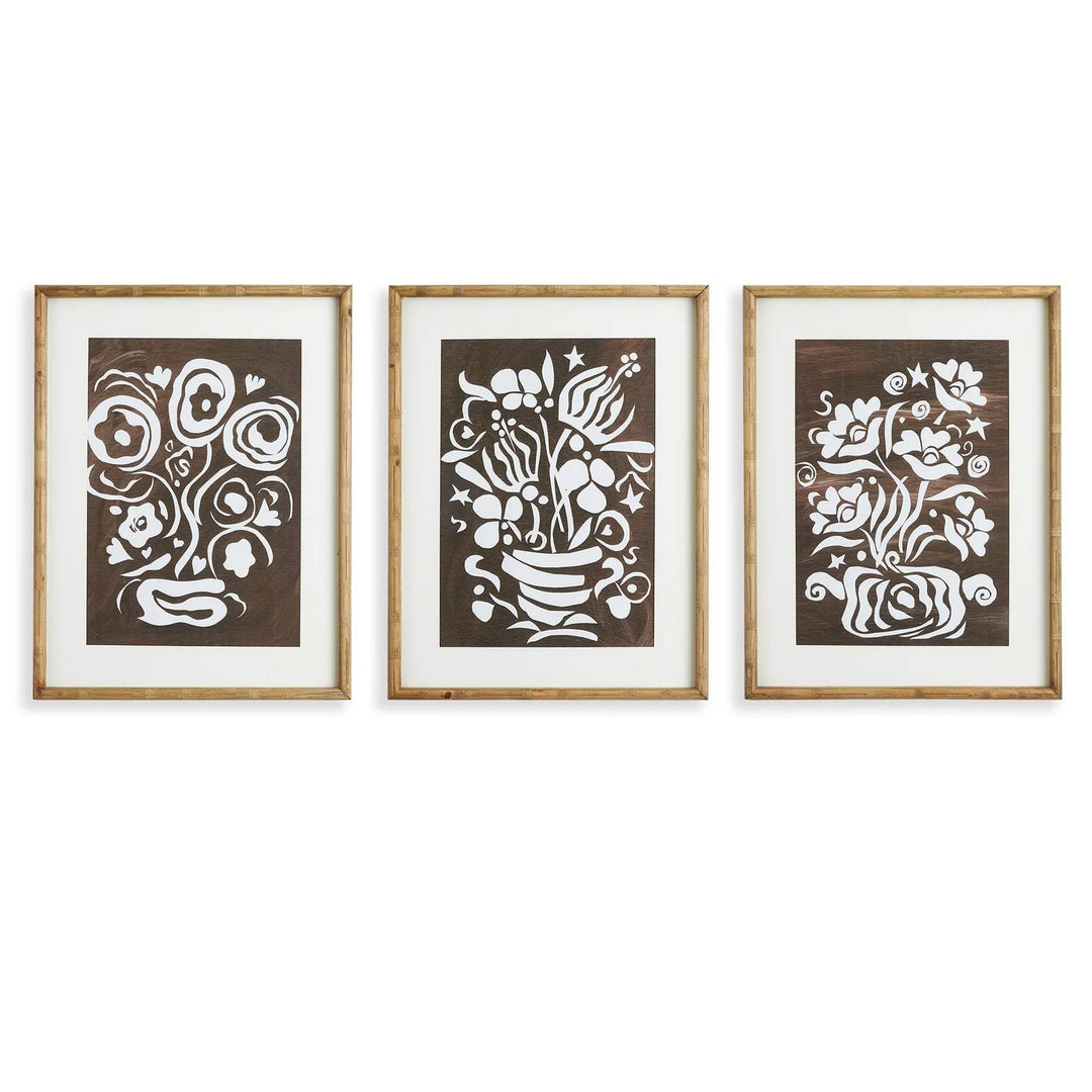 Studio image of vintage botanical cutout wall art trio with bamboo-style frames and floral white-on-brown silhouettes